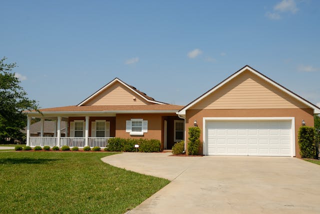 Orange house with green front lawn